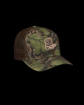 Quarterfront view of Tecovas x Mossy Oak Full Foliage Trucker - Full Foliage on plain background