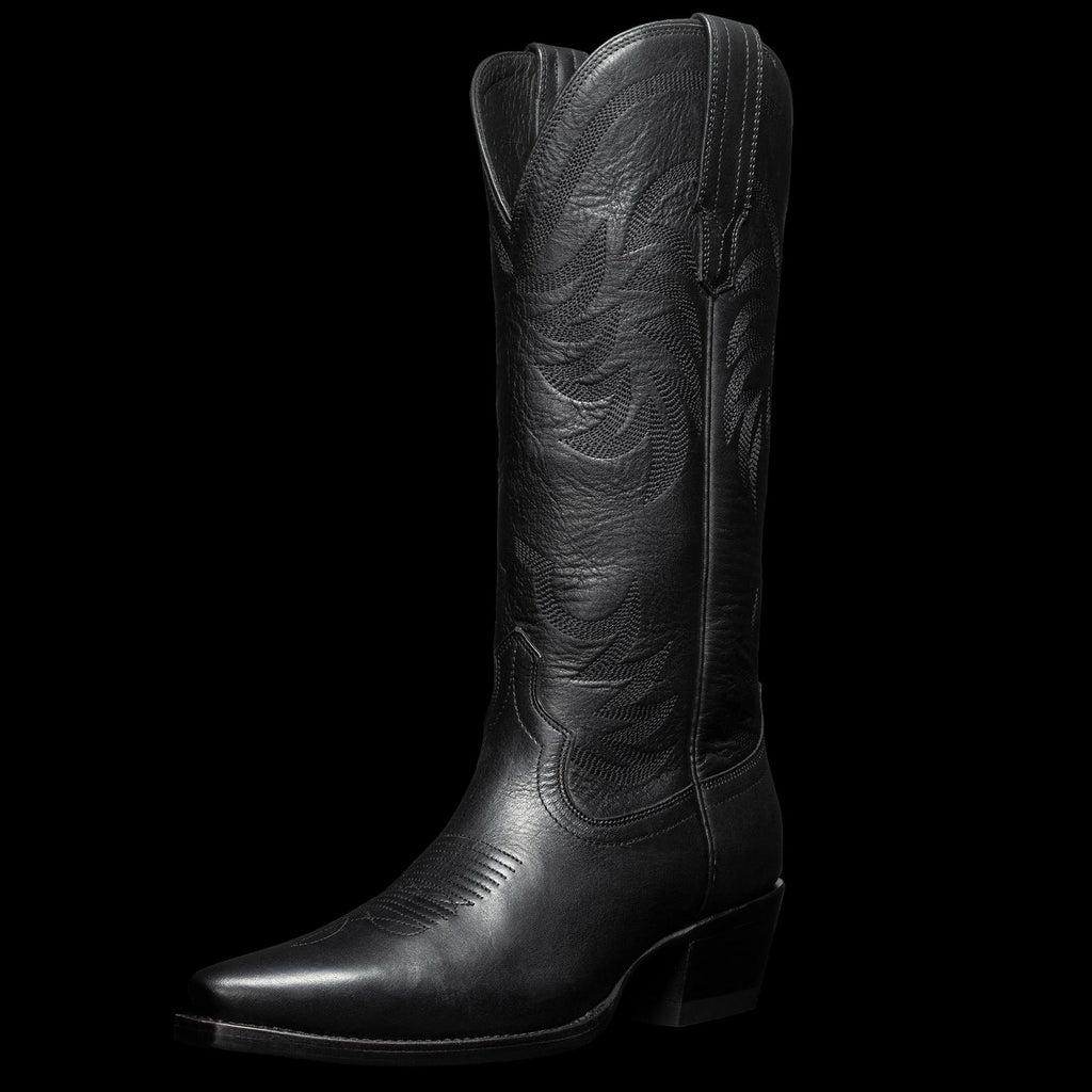A single black leather cowboy boot with decorative stitching and a pointed toe, displayed on a transparent background.