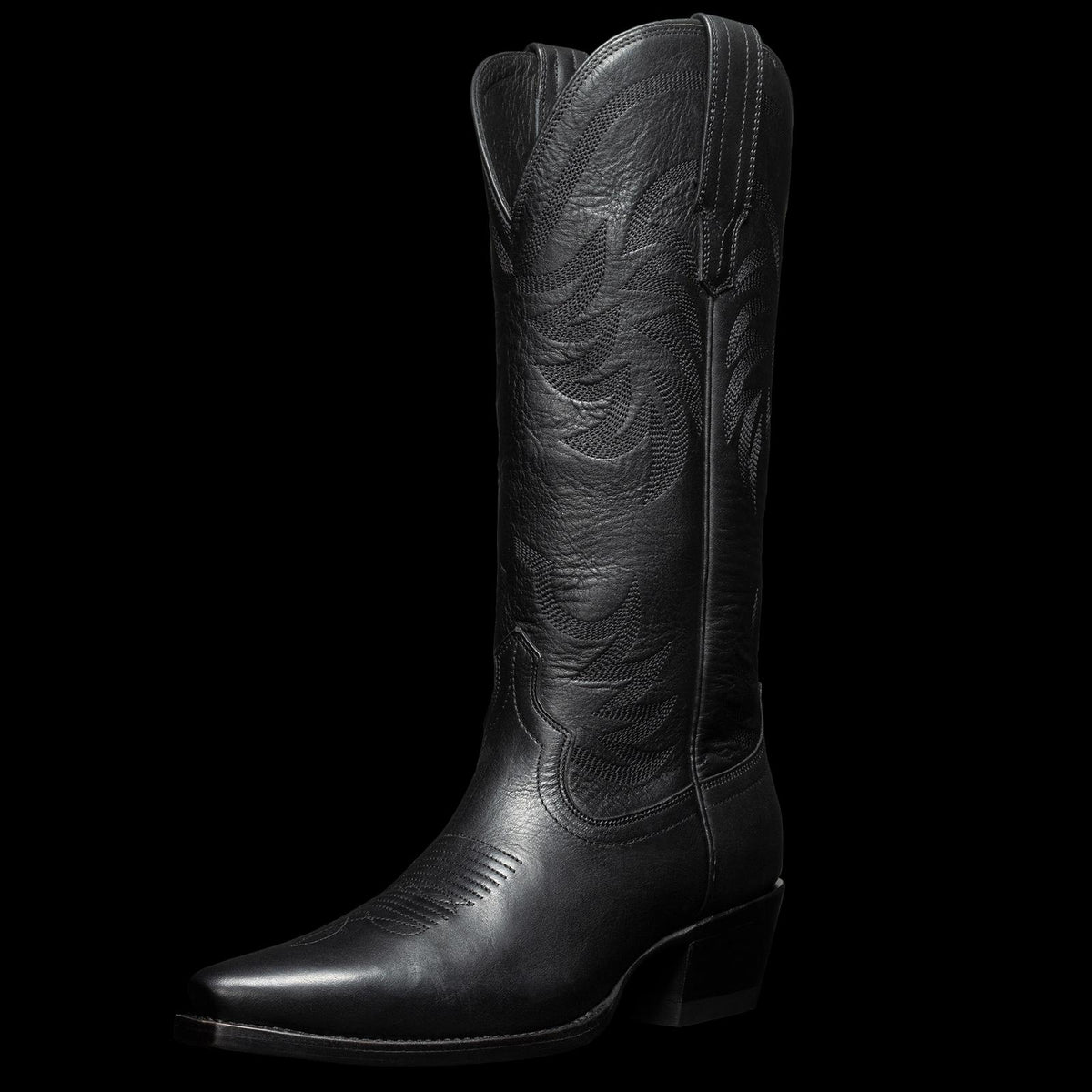 A single black leather cowboy boot with decorative stitching and a pointed toe, displayed on a transparent background.