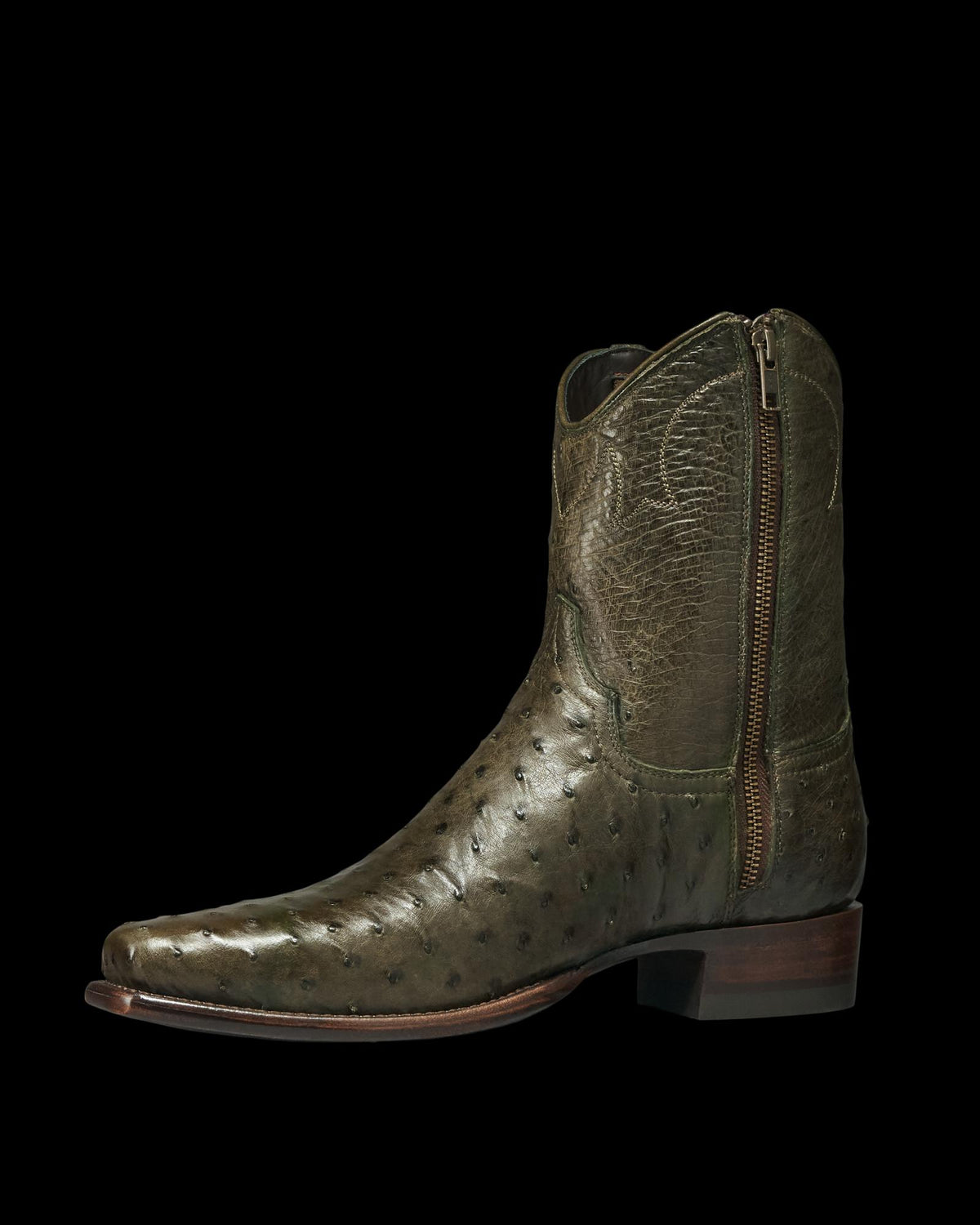 The Jack in Dark Forest Ostrich. Olive green Dark Forest Ostrich leather cowboy boot with a side zipper, low heel, and square toe, shown in a left side profile view against a white background.