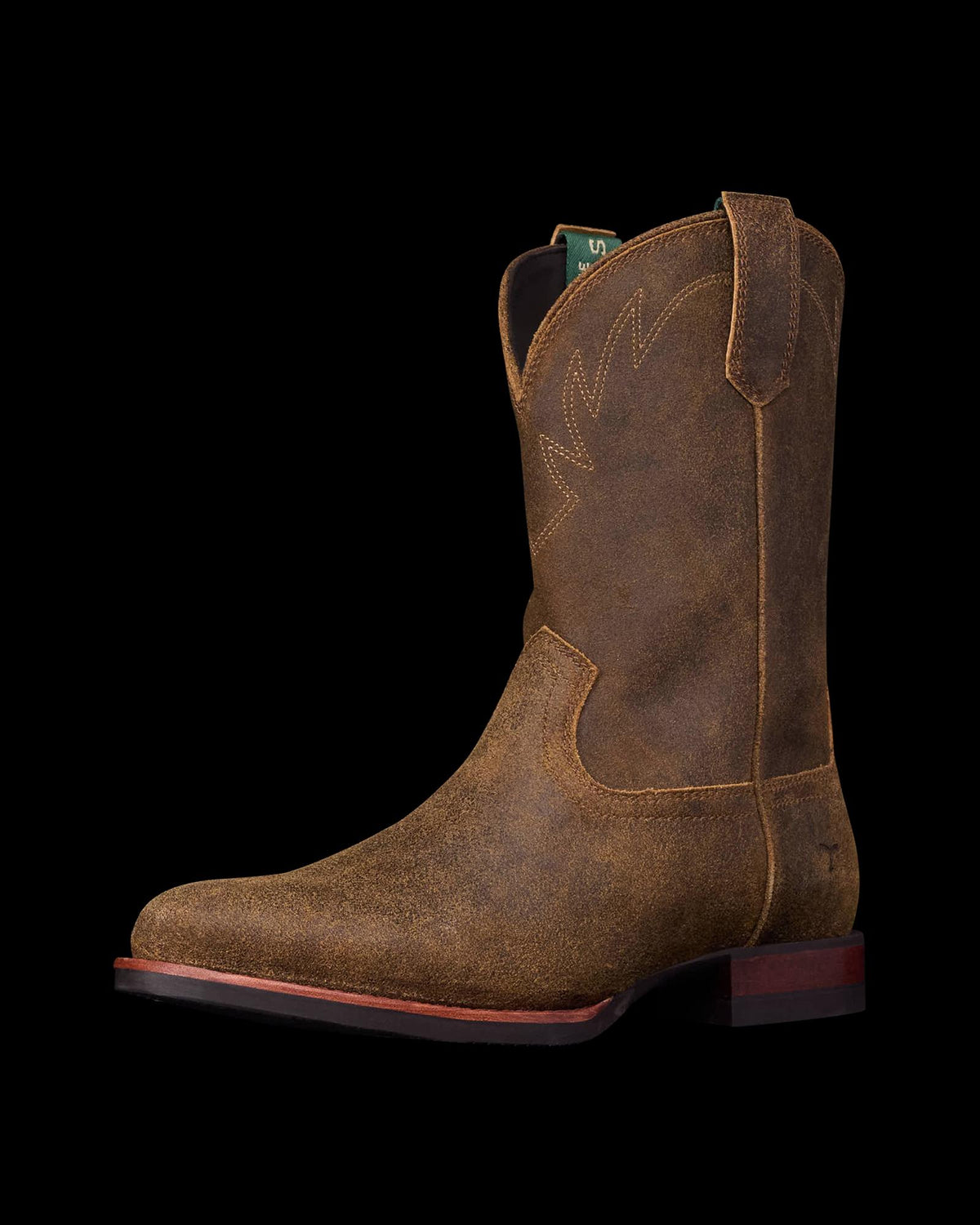 The Glen in Dustwood Roughout. A brown leather cowboy boot with decorative stitching, a low heel, pull straps, and a square toe—crafted in Dustwood Roughout—shown against a plain white background.