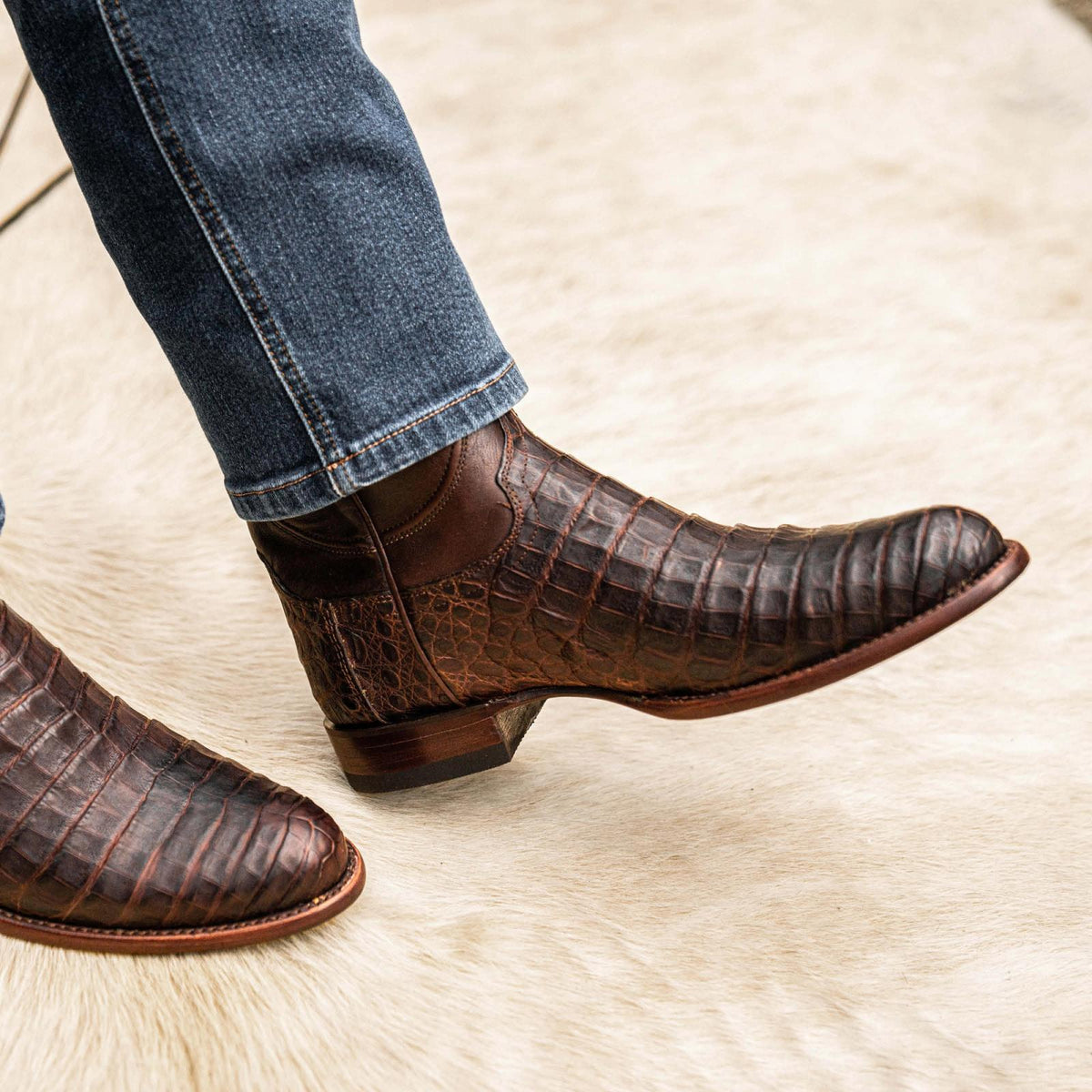 close up picture of Earl Mahogany brown cowboy boots on a man's feet