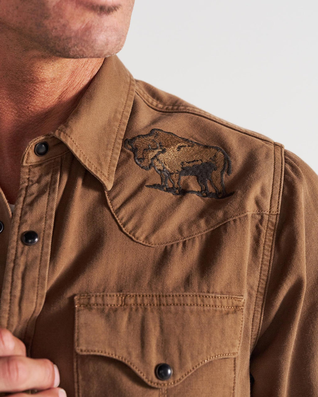 Closeup detail view of Men's Denim Pearl Snap - Tobacco
