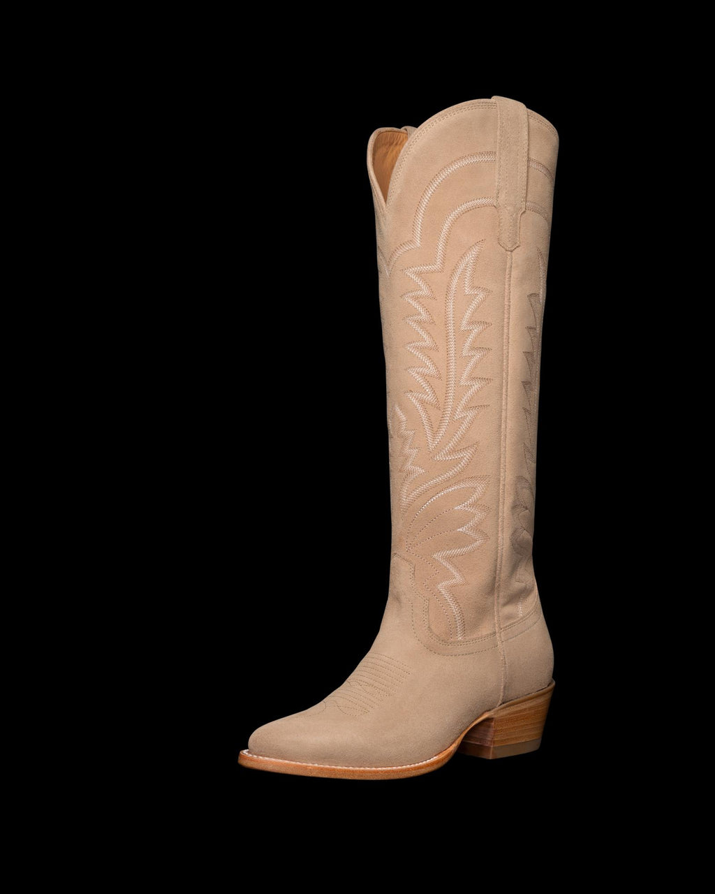 Tan cowboy boot with decorative stitching and a wooden heel, positioned against a black background.