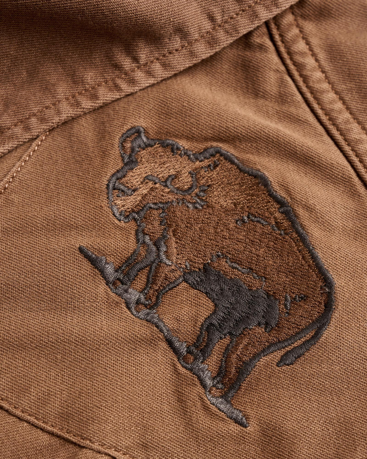 Closeup detail view of Men's Denim Pearl Snap - Tobacco