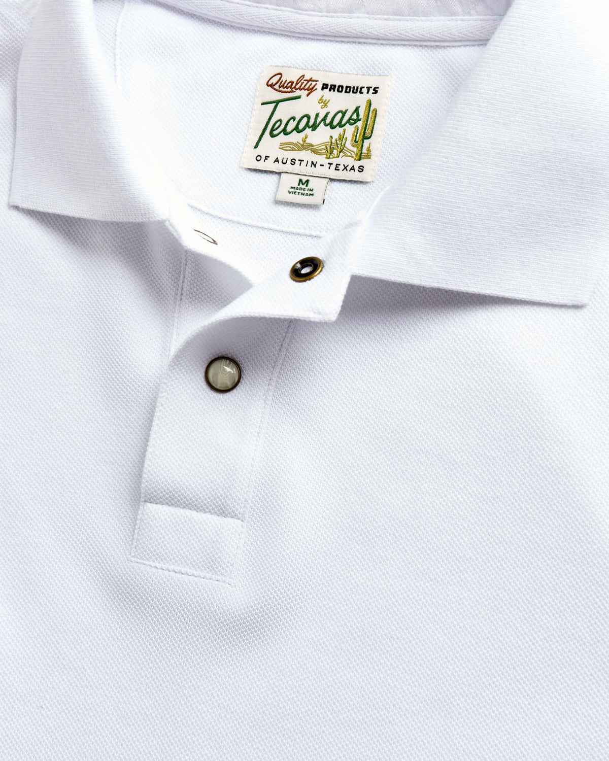 Closeup detail view of Men's Polo Pearl Snap SS - White